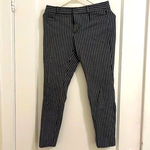 Navy blue and white striped, cropped trousers.